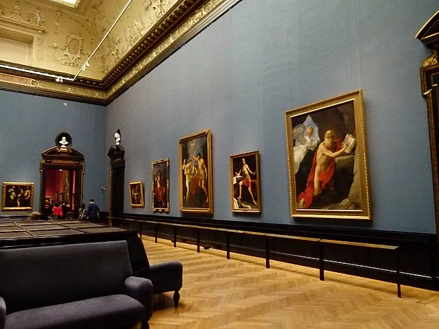 A room of the Picture Gallery with blue walls and Italian paintings